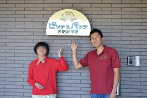 施設の看板前の様子