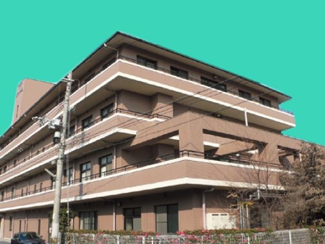 建物外観 外観 複数階建ての落ち着いた色合いの建物です。周囲に植栽があり、安心感のある印象です。
