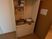 サムネイル 施設の写真 少し小さめの台所スペース。IH調理器具とシンクが設置されていて、シンクの上には洗い物を置く棚がある。