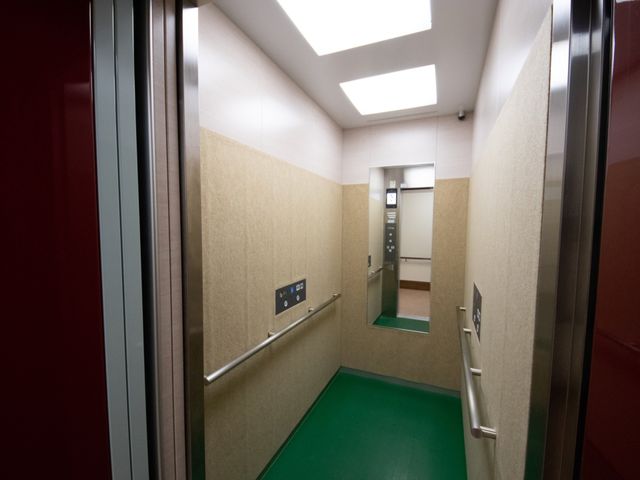 清潔感のあるエレベーター内 エレベーター 手すりが設置されたエレベーターは、広々としており車椅子もスムーズに乗降できる設計です。明るく清潔なこのスペースは、働く環境としても快適を約束します。