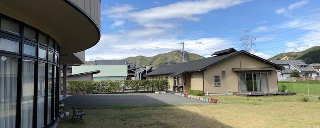 広い庭と建物外観 外観 緑に囲まれた広い庭のある施設です。心地よい空間でリラックスしながら働けます。