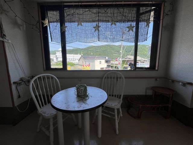 明るい空間の居室 居室 開放的な窓から自然光が差し込む居室です。テーブルセットが配置され、穏やかな時間を過ごせる空間になっています。