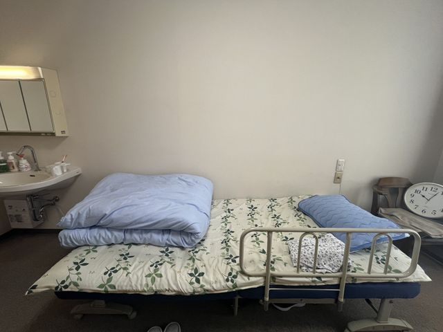 ベッドと設備の居室 居室 落ち着いた雰囲気の居室で、快適に過ごせる設備が整っています。自然な光が差し込み、心地よさを感じます。