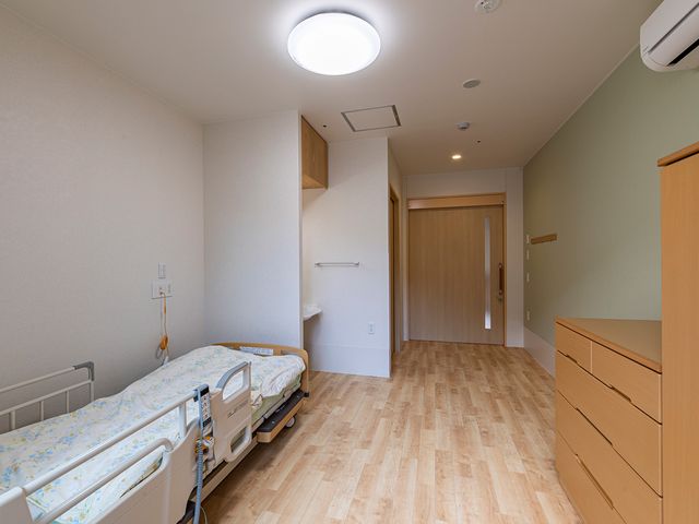 ベッドのある居室 居室 広々とした居室には、ナチュラルな木目調の床が映え、快適に過ごせる空間が広がっています。