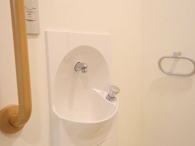 手すり付き洗面台 洗面台 快適な利用を考慮し、手すりが設置された洗面スペースです。清潔感のあるデザインで安全性にも配慮されています。