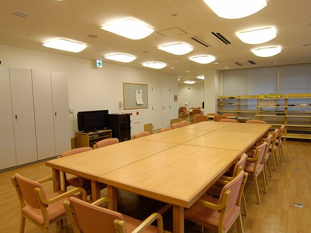 大きなテーブルの部屋 多目的室 広々とした明るい多目的室で、交流や活動が快適に行えます。柔らかな照明が特徴的です。