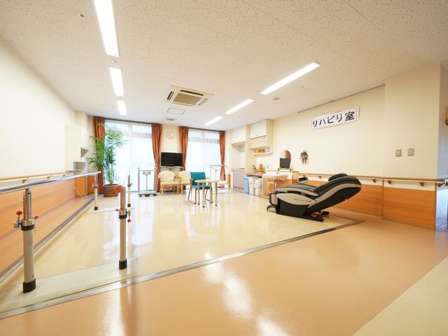 広々としたリハビリ室 リハビリ室 広くて明るい機能訓練室で、リハビリ器具が整っており、スタッフのサポートも充実しています。適切な設備がそろい、利用者の快適な訓練を支える環境です。