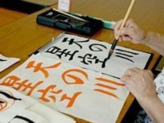 書道をする手元と紙