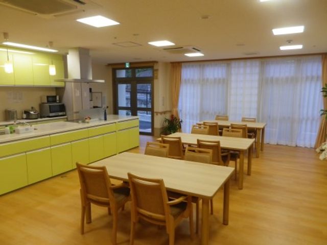 キッチン付き食堂 ダイニング ゆったりとした食堂では、温かい色合いの家具がくつろぎの時間を提供します。キッチン設備も整い、共同で料理が楽しめる環境です。
