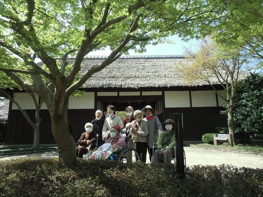 庭で集うスタッフと入居者