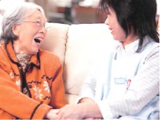 笑顔のおばあさんと職員