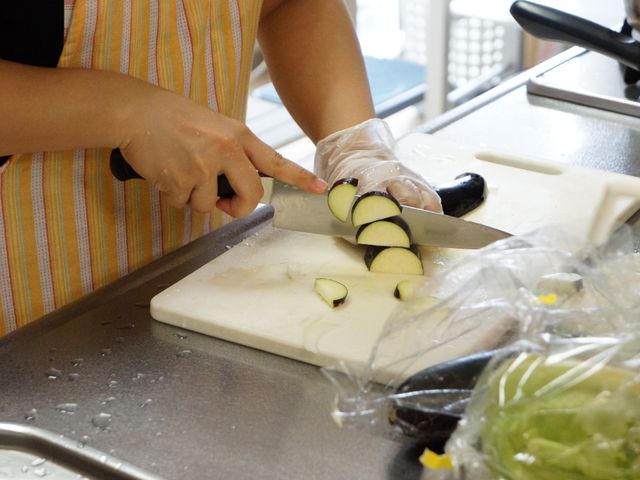手作業で野菜を切る様子 調理風景 丁寧に野菜を調理する手元が見えます。新鮮な食材を使った家庭的な食事作りにこだわる職場です。