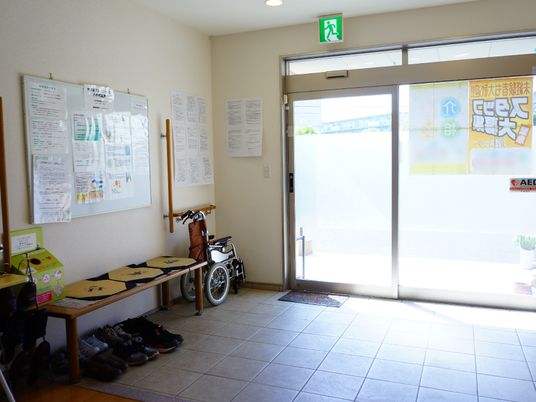 エントランスの掲示物と車椅子