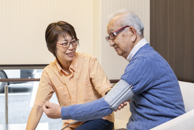 血圧測定を受ける笑顔の利用者
