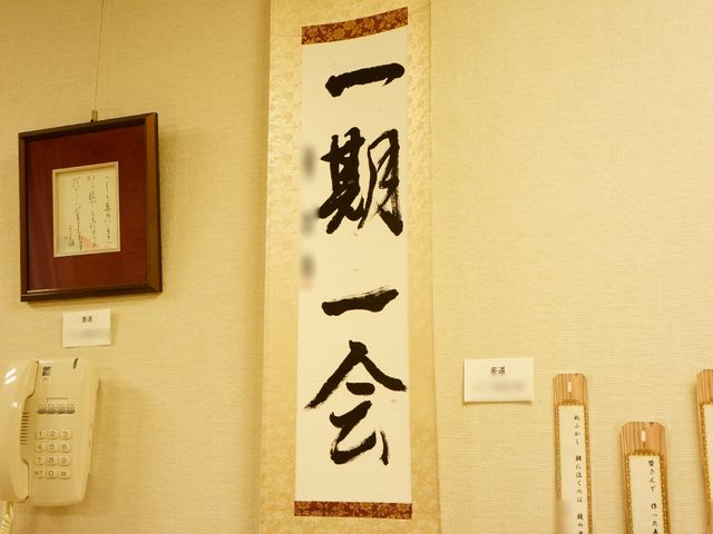 掲示物が飾られた壁面 入居者の作品 心温まる書が飾られた壁面が、訪れる人々に和やかな印象を与えています。明るく清潔感のある通路で、来訪者の方々をお迎えいたします。