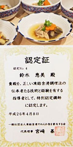 認定証と料理の皿 料理   認定証が飾られた、彩り豊かな料理が並ぶ場面です。技術と経験の証として示されています。