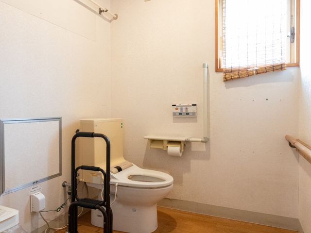 設備が整ったトイレ トイレ 窓から自然光が入る明るいトイレです。介護用具が設置されており、安全性に配慮しています。