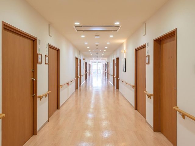 廊下 施設内の廊下は、車いす同士でもすれ違えるほどの広さです。適切な高さに手すりを設置しており、歩行移動をサポートいたします。