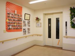 廊下に花飾りのエレベーター