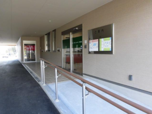 明るいエントランスの外観 スロープが完備されたエントランスは、明るくて開放感があります。手すりも設置され、安全に配慮された設計です。