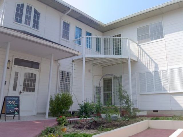 清潔な建物の外観 外観 庭の緑に囲まれた、通気性の良い環境です。明るい外観が魅力的な職場です。