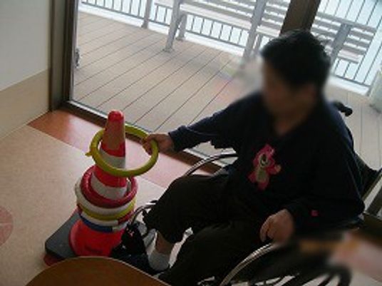 車椅子の人物と窓辺