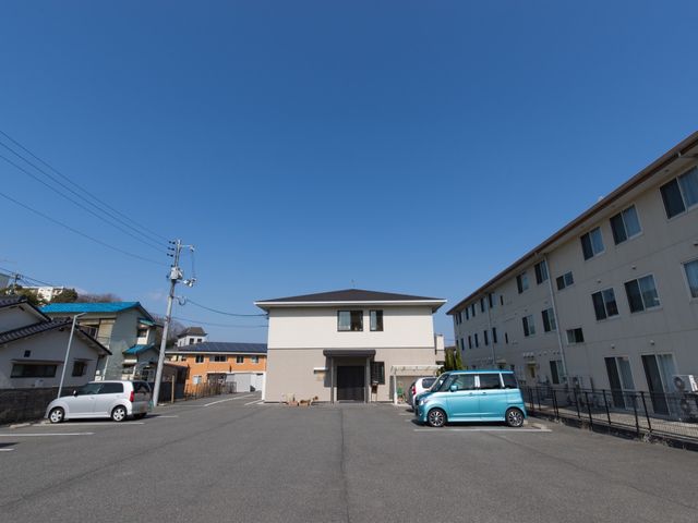 広い空と建物のエクステリア 外観 広々とした空間に位置する建物は、清潔感があり、快適な環境でお仕事ができそうです。明るい陽光が降り注ぐ、ゆったりとした外観です。