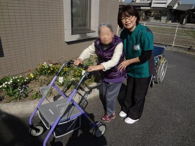 笑顔のスタッフと利用者の散歩