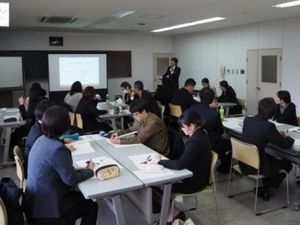 会議室で説明を聞く人たち