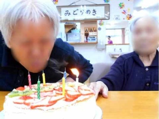 誕生日ケーキの前の笑顔