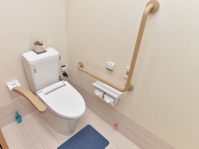 バリアフリー設計のトイレ トイレ 安全かつ便利なサポートバー付きのトイレです。清潔感があり、快適な利用が期待できます。