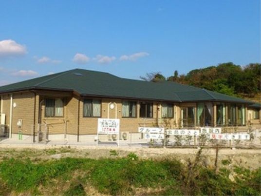 青空と緑の外観