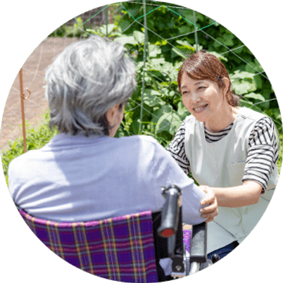 笑顔の介護士と利用者　庭