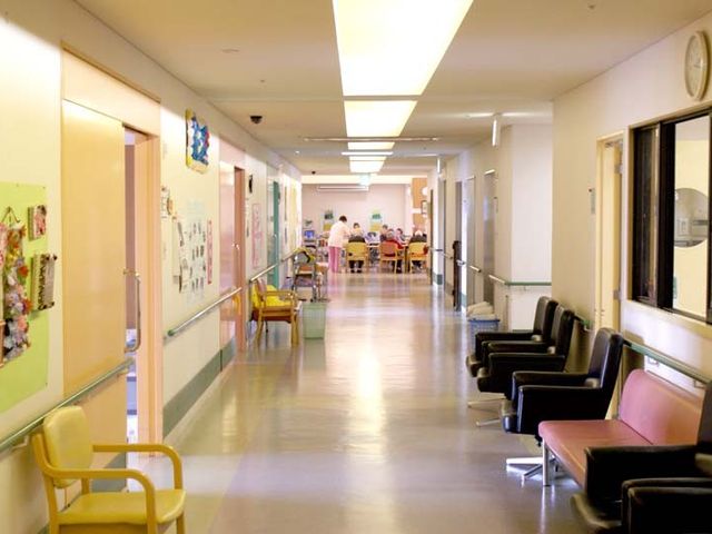 長い廊下 廊下 明るく広々とした廊下には、椅子が並んでおり、ゆったりと過ごせます。奥ではスタッフが作業しています。