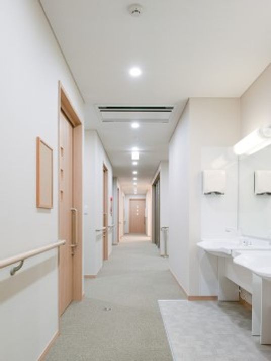 「グループホーム「やまびこ」」の廊下。白色をベーズに明るく、動きやすい廊下になっている。