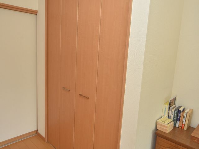 きれいな木製のクローゼット クローゼット 整然とした収納空間が確保された洋室を備え、快適な生活が支援されています。