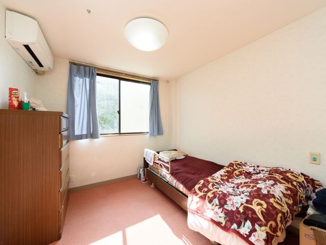 快適な居室の一角 居室 陽当たりの良い清潔な居室で、個人のプライバシーがしっかりと守られた環境です。小物を置けるスペースも充実しており、快適な生活をサポートいたします。