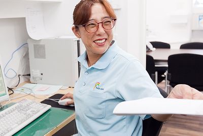 書類を手渡すスタッフ