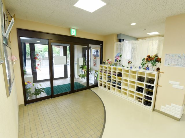 エントランスの明るい風景 玄関 明るく開放的なエントランスです。玄関には花々が飾られ、訪れる人々を温かく迎えています。