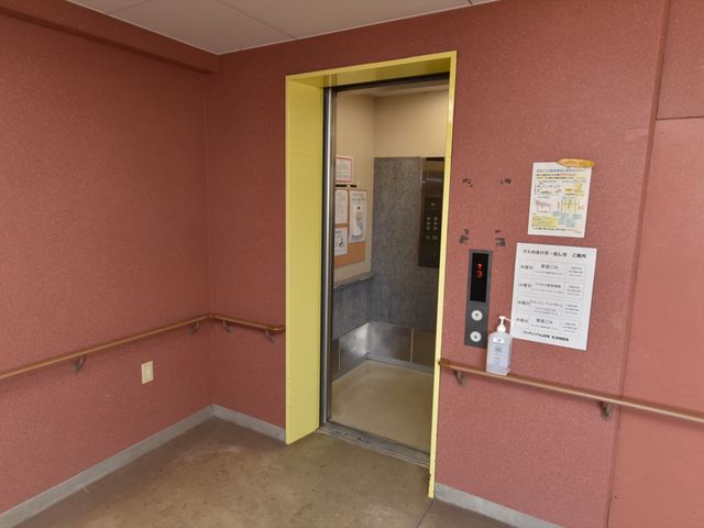 エレベーター前の案内掲示 エレベーター 手すり付きのエレベーターホールは、すべての方が移動をしやすい工夫がされております。各階の案内や消毒液も完備しています。