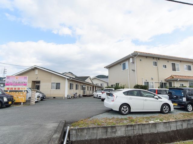 明るい外観の建物 外観 広々とした駐車場があり、明るい色合いの建物がお迎えします。利便性とゆとりの空間を感じられる場所です。