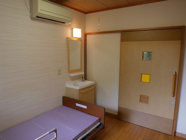 居心地の良い居室 居室 落ち着いた色合いの居室です。手すりや洗面台があり、安全性と利便性が考慮されています。