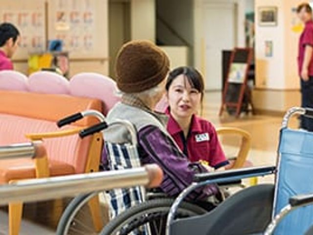 会話するスタッフと利用者の多目的室 多目的室 スタッフと利用者が談笑し、心温まるコミュニケーションが感じられるスペースです。