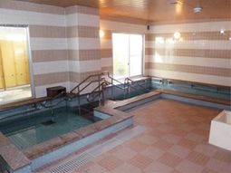 明るい照明の広々浴室