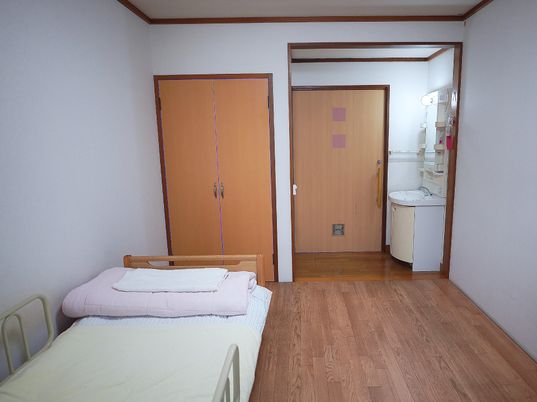 居室のベッドと洗面所