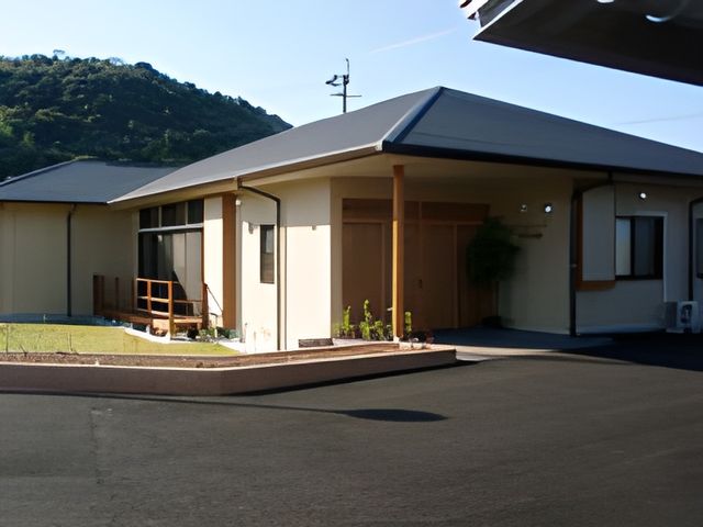 庭のある建物 外観 広々とした庭がある環境で、自然を感じながら快適に過ごせます。就業希望者に理想的です。