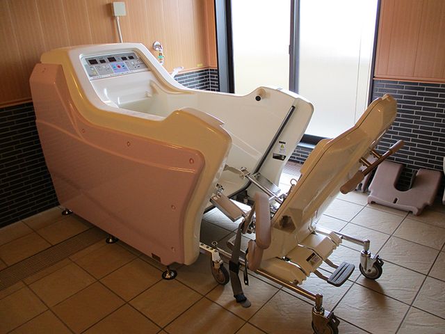 介護浴槽の浴室 浴室   移乗しやすい機器付きの浴槽が設置された浴室です。窓から光が入り、明るい印象です。