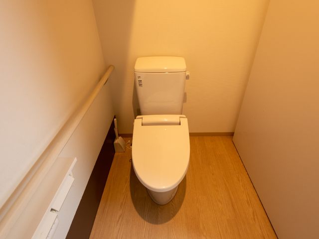 清潔なトイレスペース トイレ 手すり付きで安全性を考慮した設計のトイレです。使用者の自立を支援し、快適な日常をお送りいただけます。