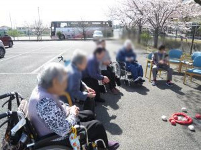 屋外での活動風景 庭 日差しの中、車椅子の方々が楽しそうに交流を深めている様子です。リラックスできる空間です。
