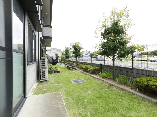 緑あふれる施設の庭 庭 開放的で穏やかな屋外スペースが広がっており、憩いの時間を提供しています。